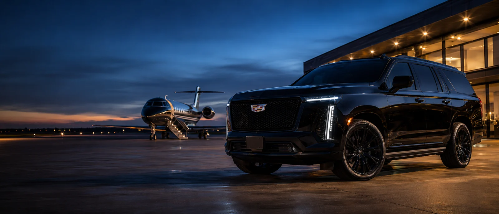 Black Cadillac Escalade chauffeur SUV beside a private jet at a Los Angeles FBO at dusk — VIP airport transfer